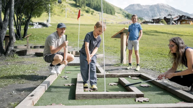 Family mini golf (parents and children) on the Val d'Isère green front in summer